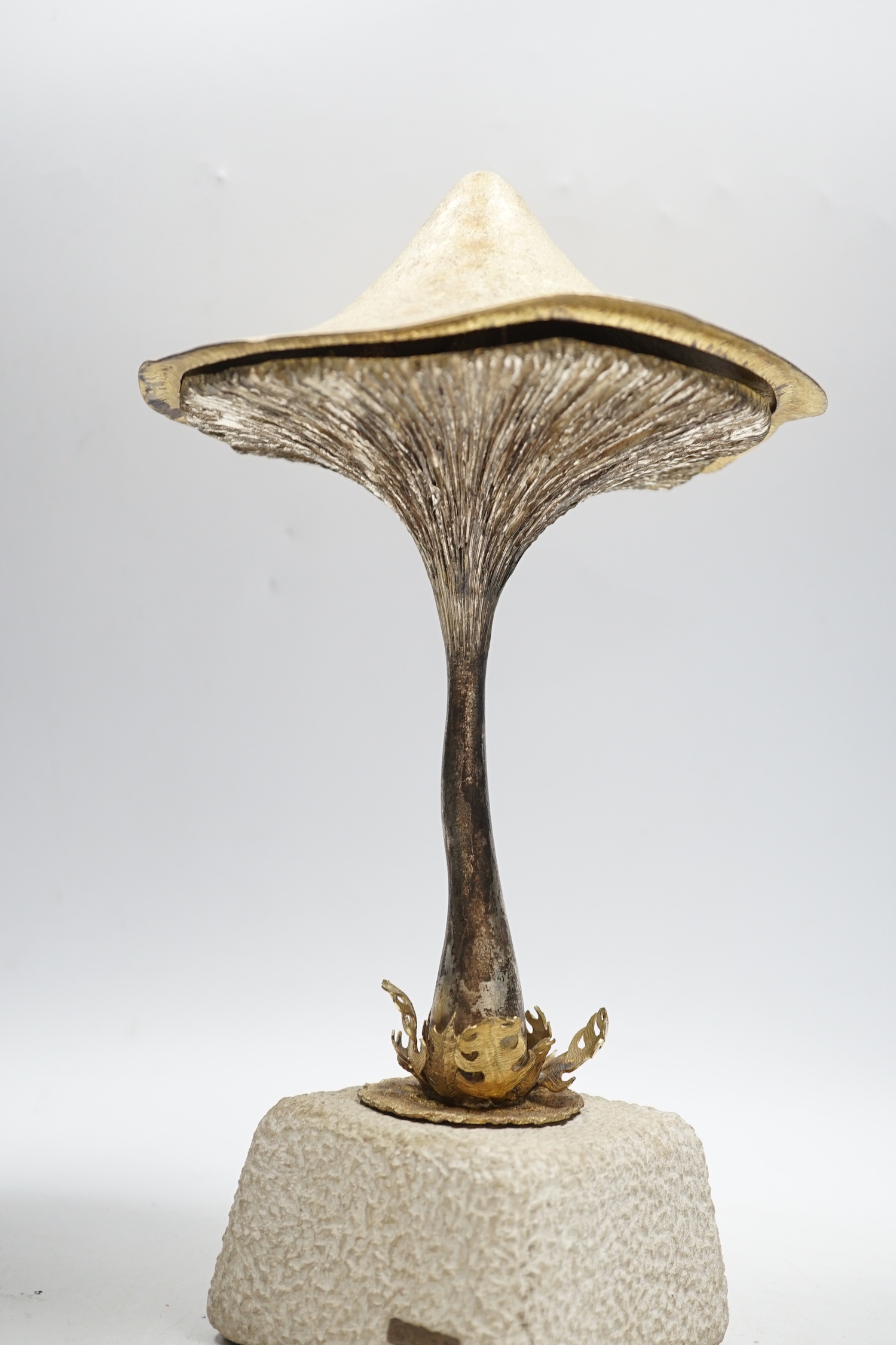An Elizabeth II limited edition novelty surprise mushroom, by Christopher Nigel Lawrence, London, 1976, opening to reveal a pixie fishing, no.2/8, on a simulated rock base, overall height 29.5cm, with certificate.